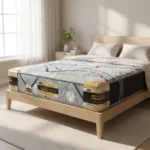 Queen-size mattress on a light wooden bed frame in a bright bedroom with natural light and a plant on a bedside table